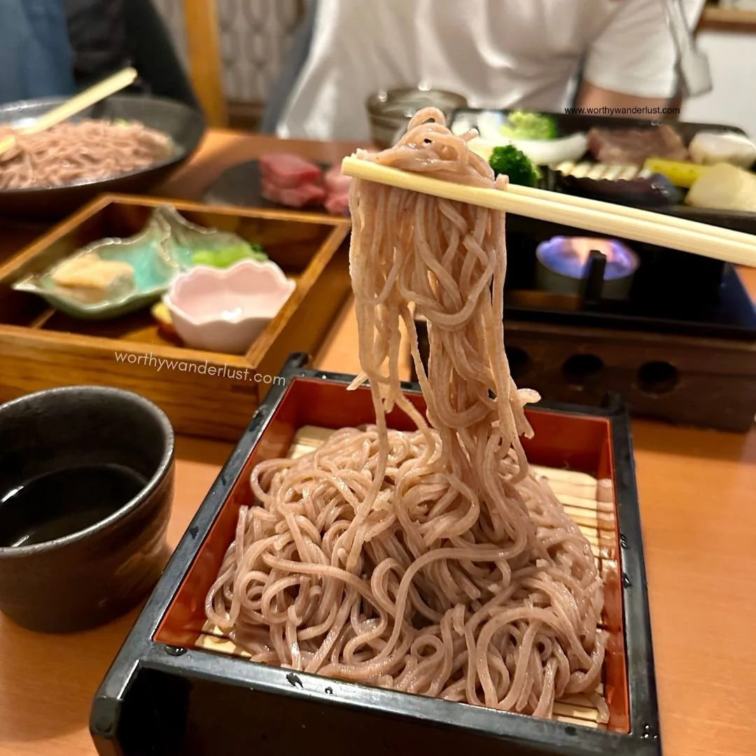 Chopsticks holding up kibi soba in Toraiya, Kurashiki
