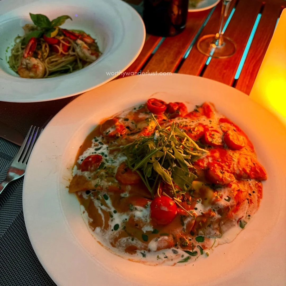 Seafood ravioli dish and another pasta dish