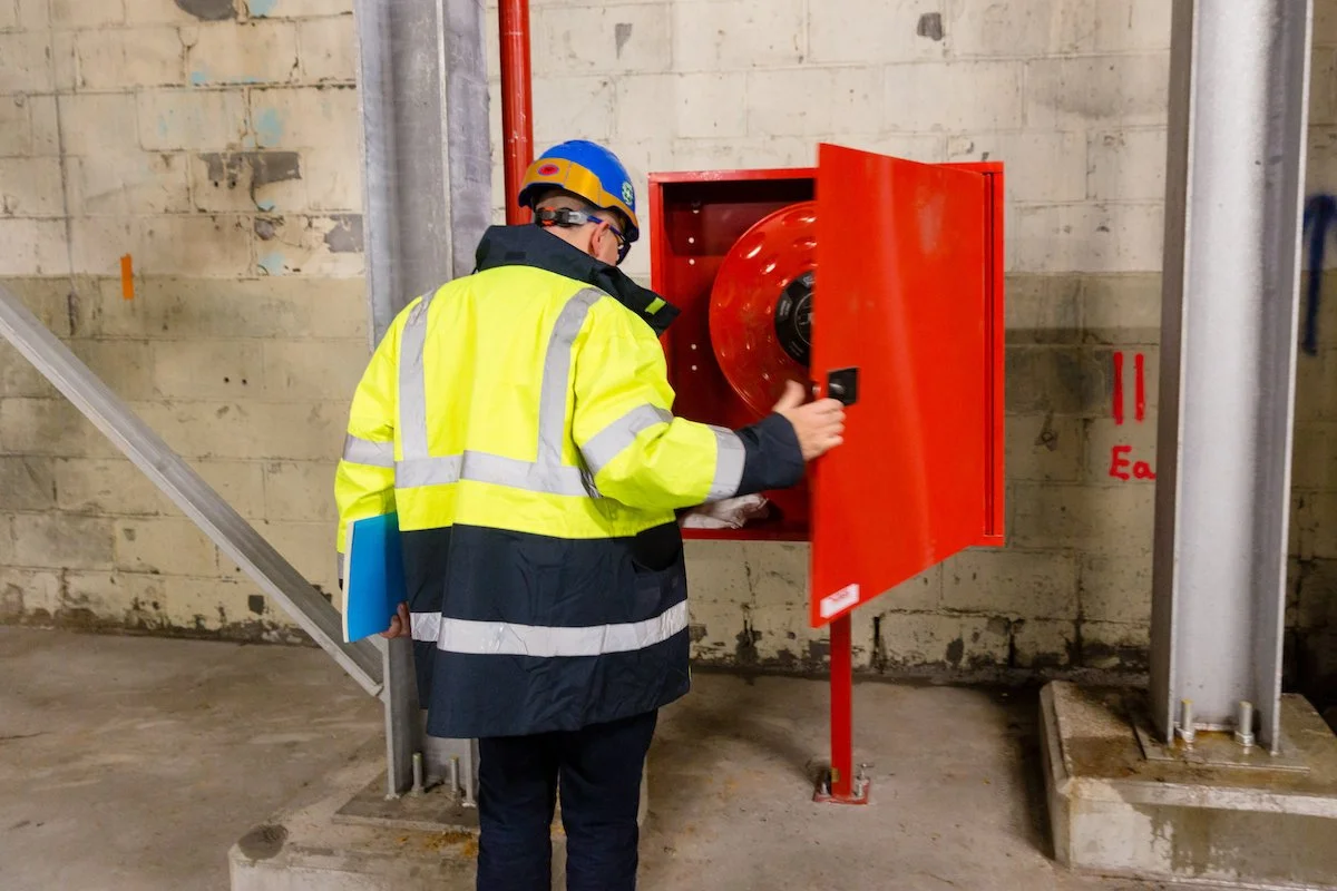 Man inspecting a fire distinguisher