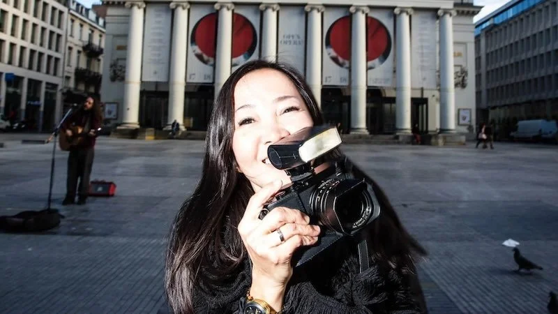 Learn street photography in Brussels photo of a girl shooting with flash