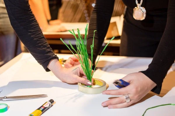People making a green tree during a workshop