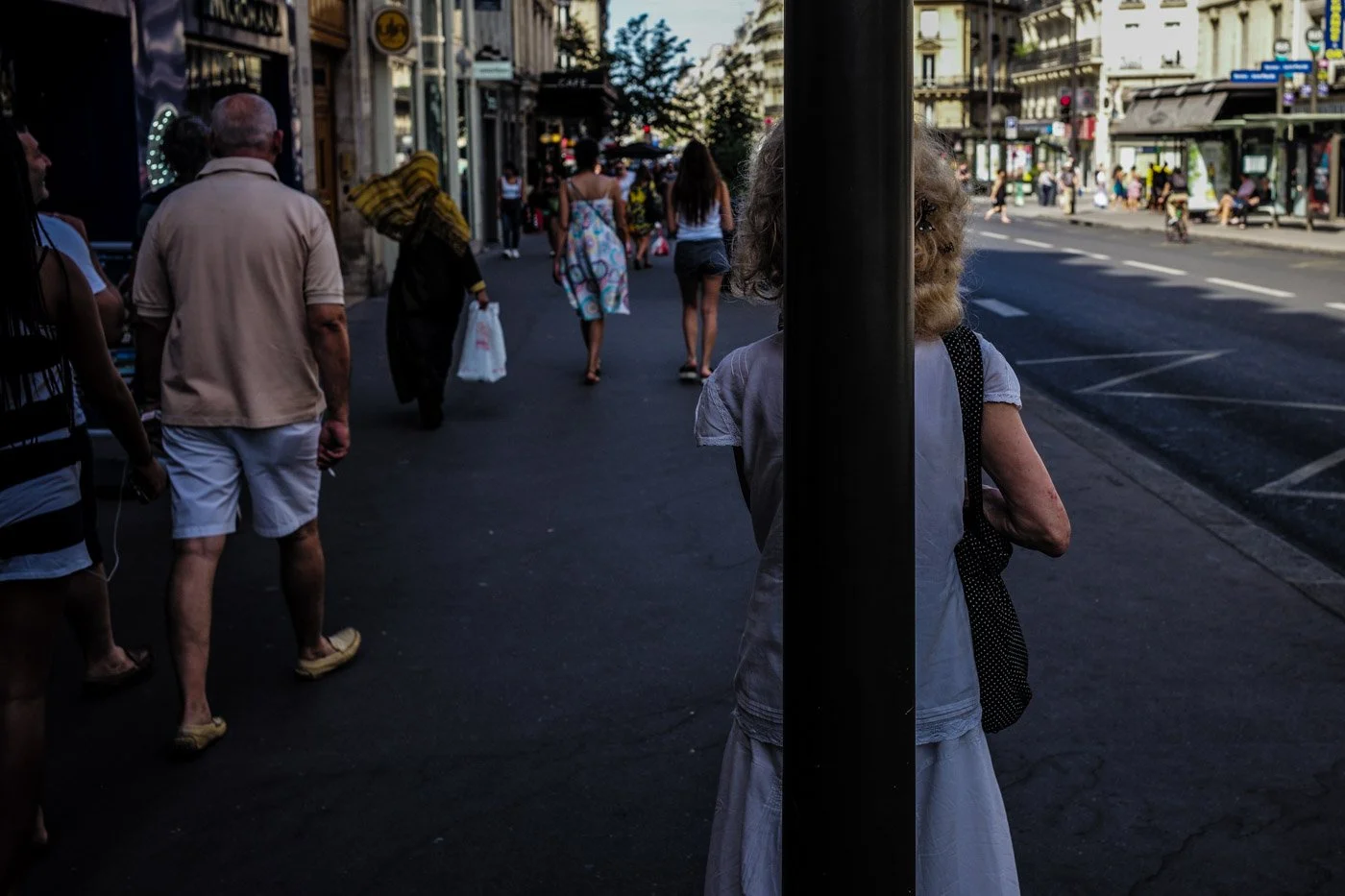 femme derrière une lanterne en photographie de rue
