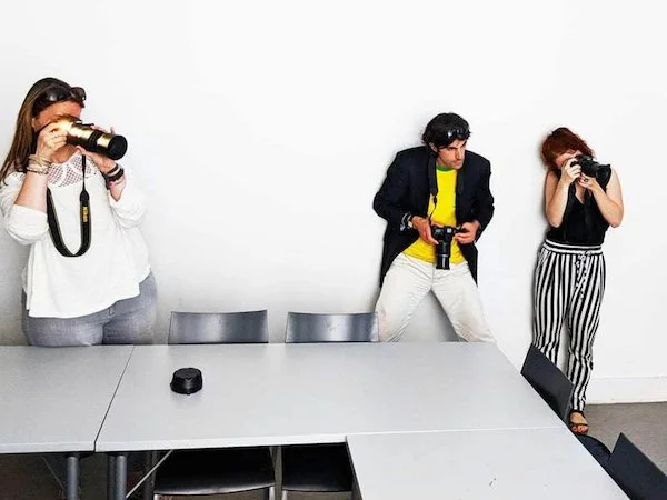 Students testing their cameras during a photography workshop