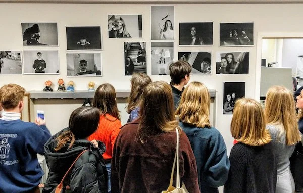 photo of students looking at work during a photo workshop