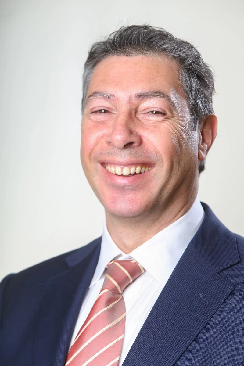 Homme souriant en costume et cravate rayée