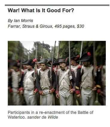 Soldiers in historical uniforms participating in a reenactment of the Battle of Waterloo.