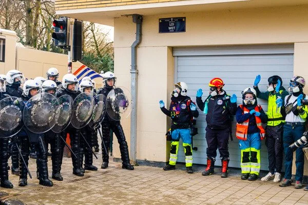 police and healthworkers during a protest; reportage