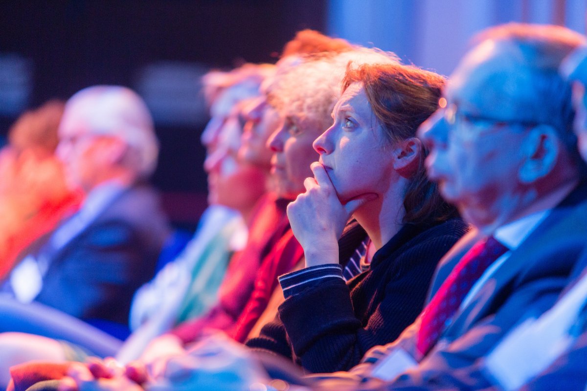People sitting in a row during a conference, beautifully photographed by a professional photographer