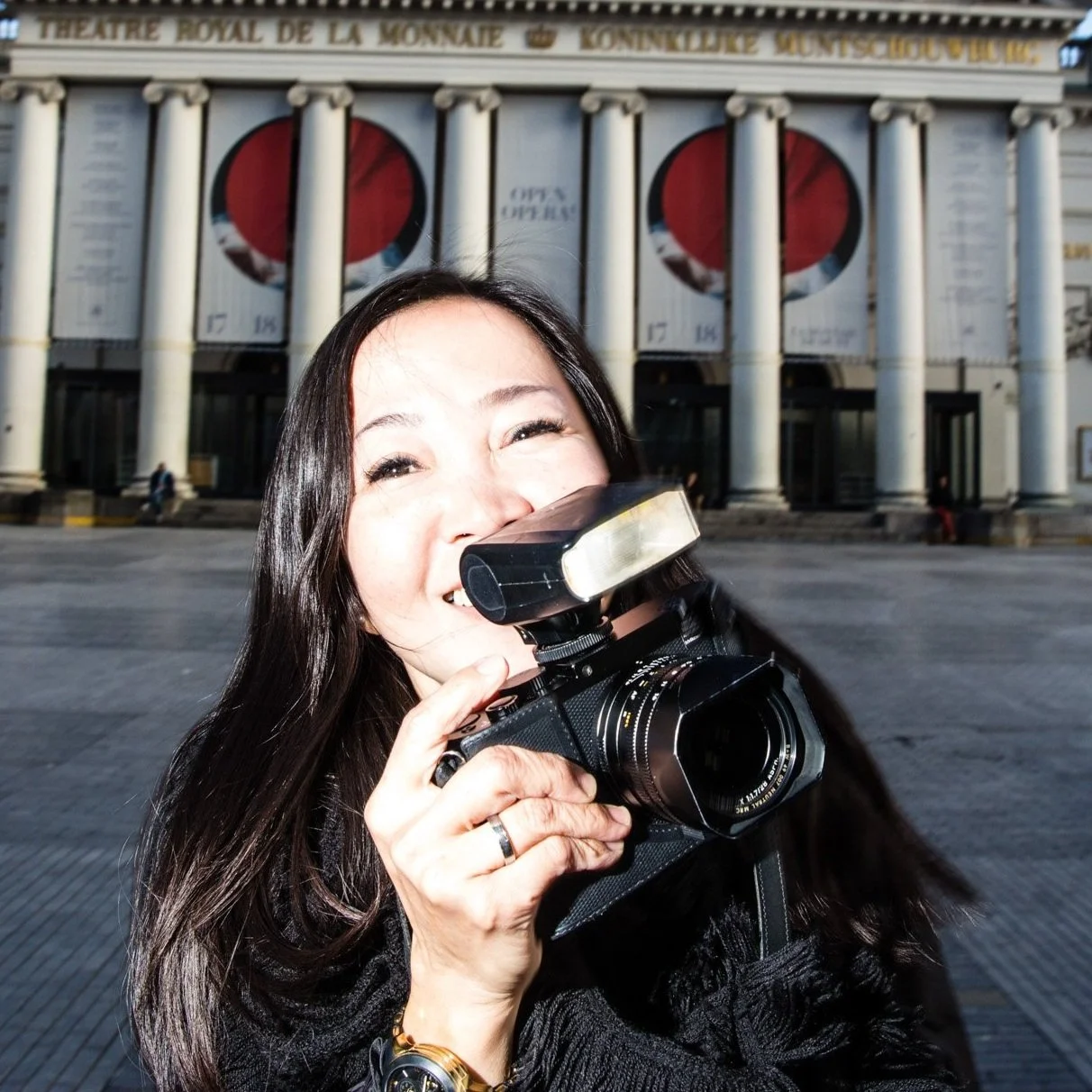 a woman with a camera during a street photography workshop in Brussels