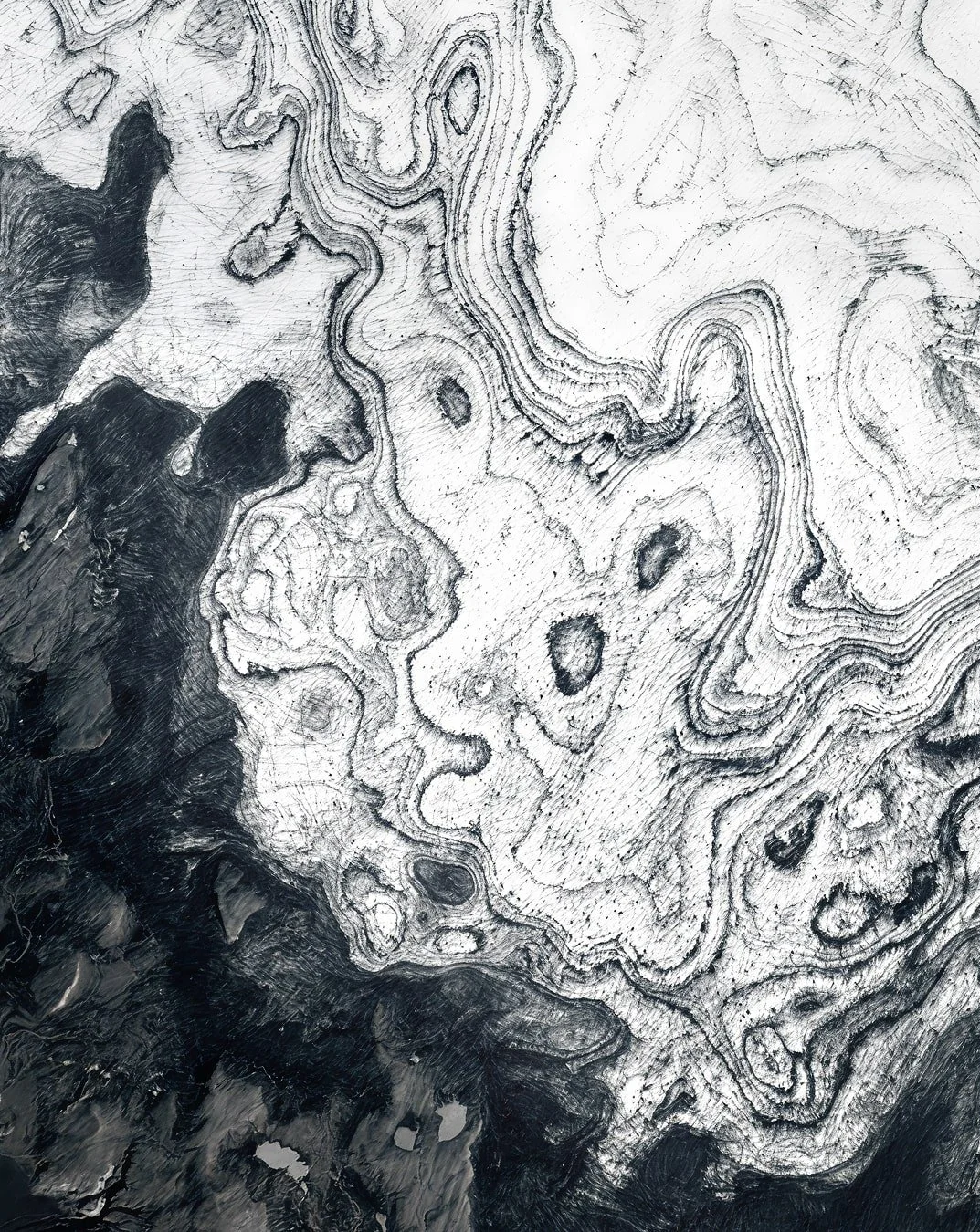 satellite image of vatnajökull, white ice field with black patterns of ash and sediment