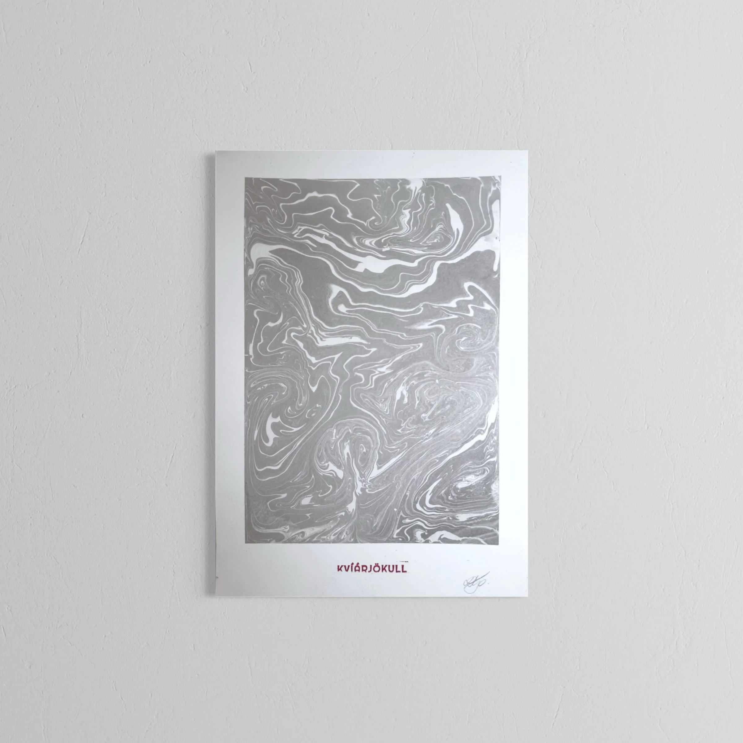 A handmade printwith an abstract grey and white swirling pattern, bordered by a white frame, with text at the bottom reading "KVÍARJØKULL" and a signature.