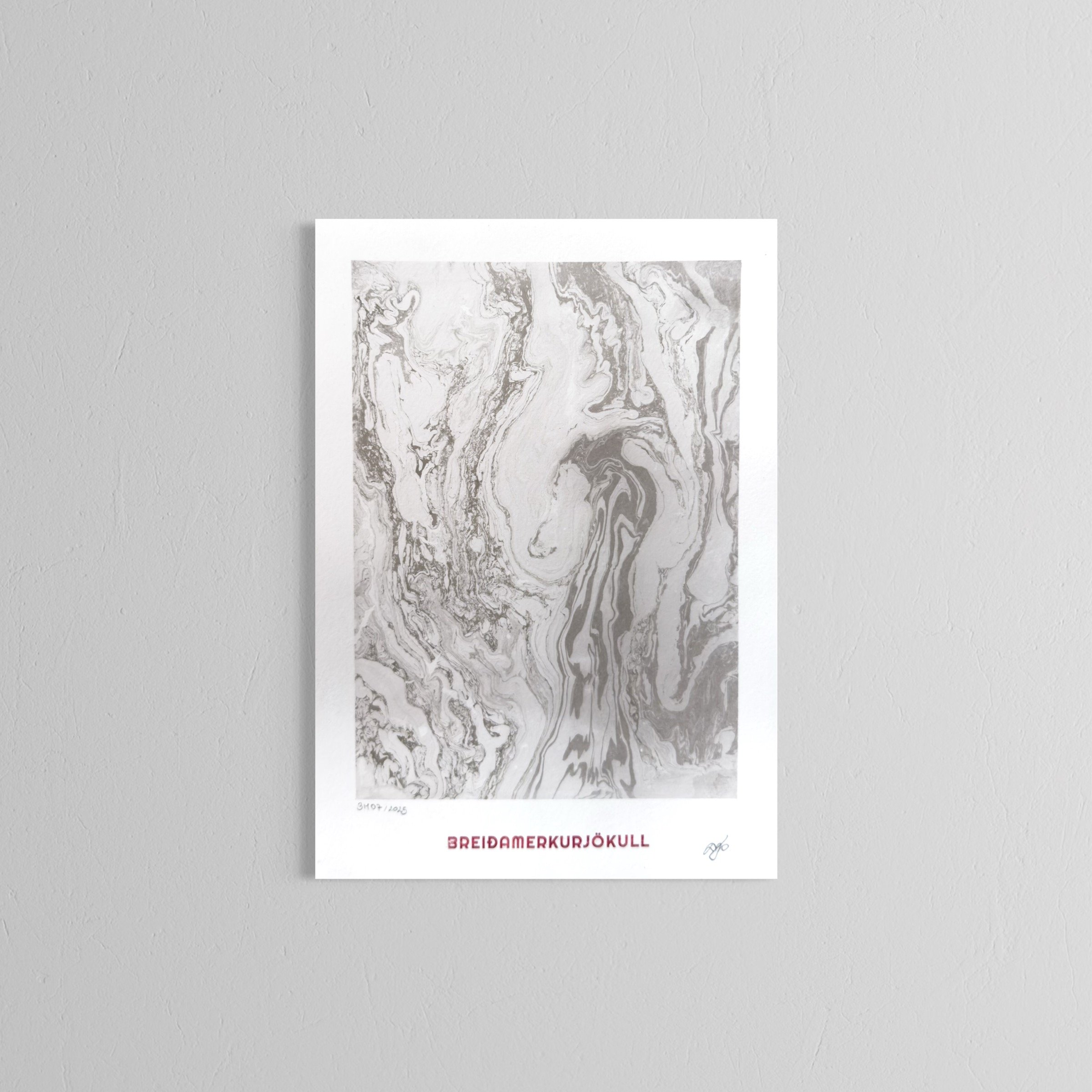 A handmade print with abstract black and white marbled artwork and the word "BREIDAMERKURJÖKULL" written in red at the bottom.