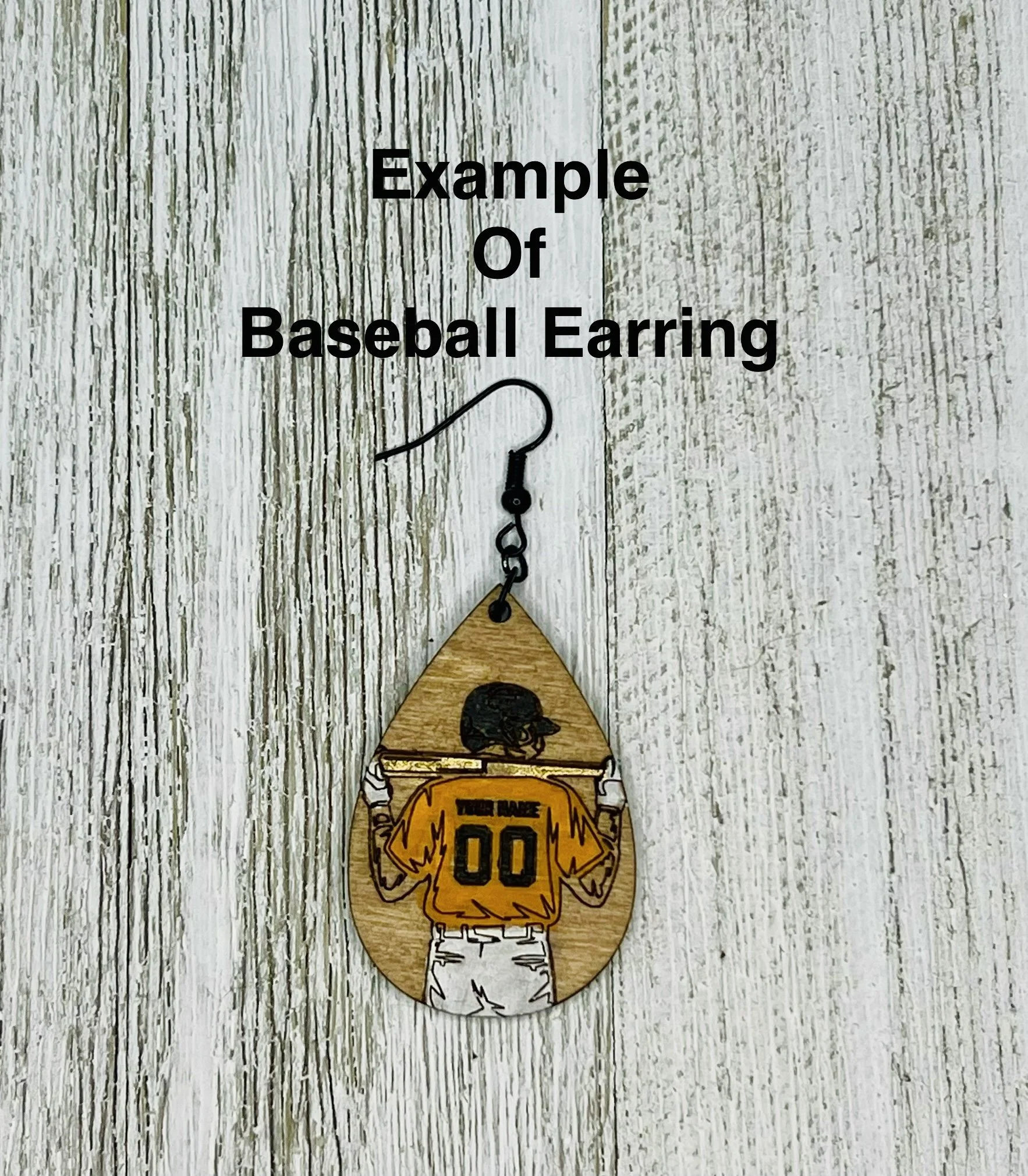 A sign featuring a wooden cutout of a hockey player wearing a yellow jersey with the number 00, standing on a round wooden base. The sign has a chain above the cutout for hanging and text above the chain that reads "Example Of Baseball Earring" with an illustration of a baseball earring hanging below the text.