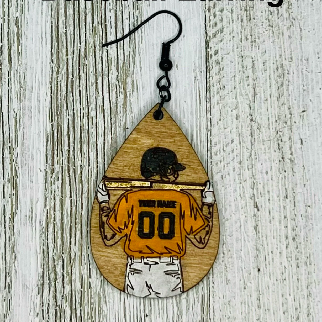 Custom engraved wooden earrings featuring a football player with the number on back of jersey. Handprinted with hypoallergenic hooks.