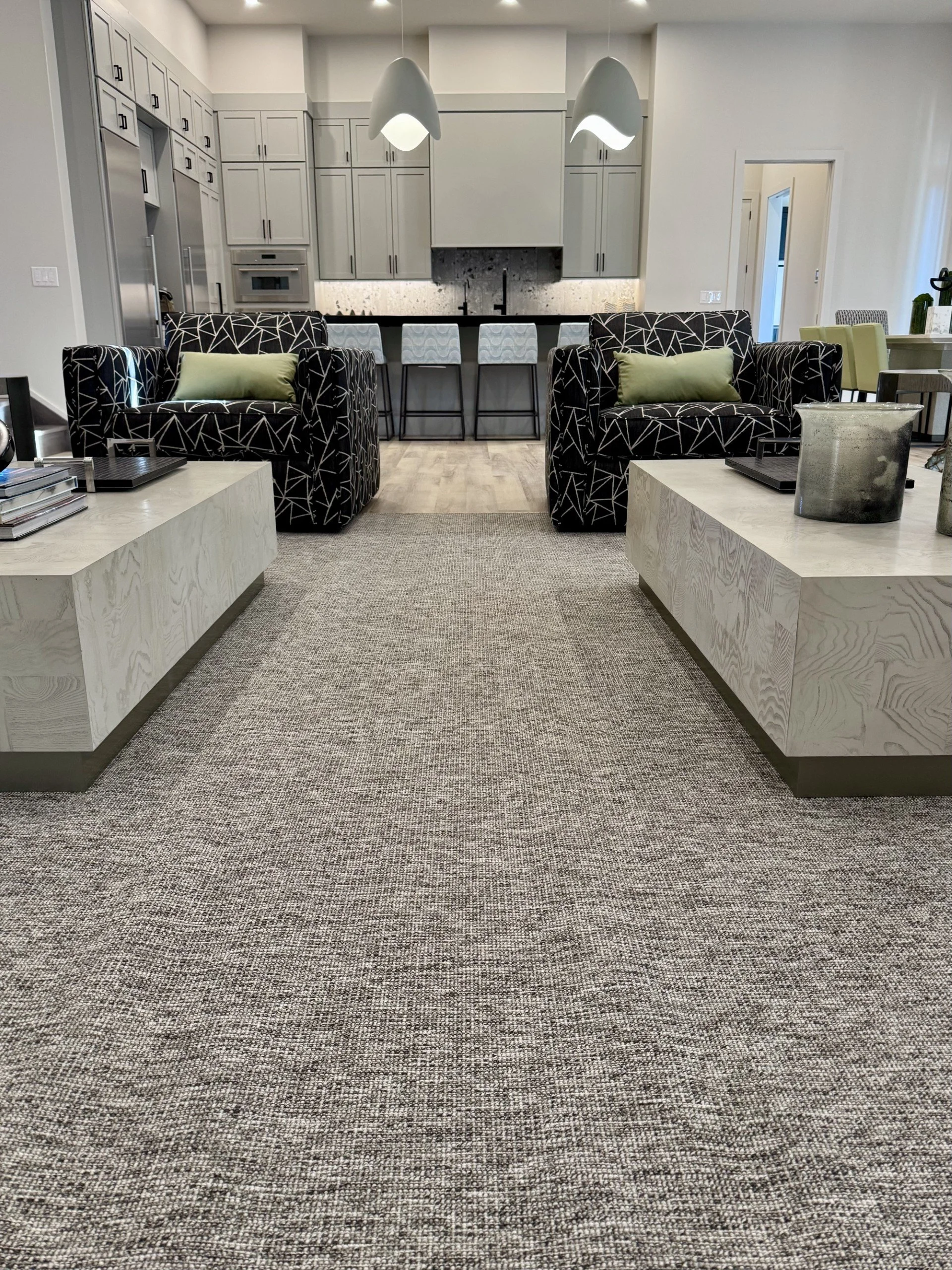 Black patterned channel tufted swivel chairs in a colorful modern beach house living room