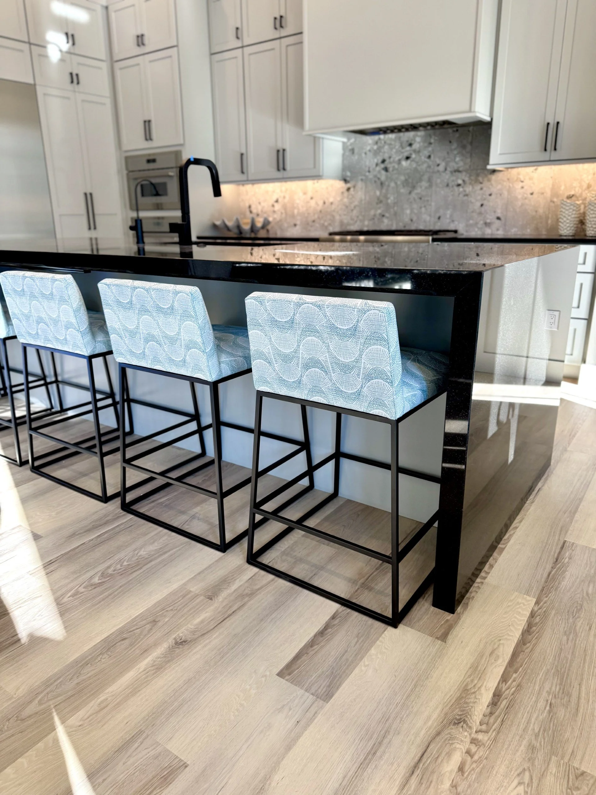 Kitchen barstools in blue wavy fabric at gray kitchen