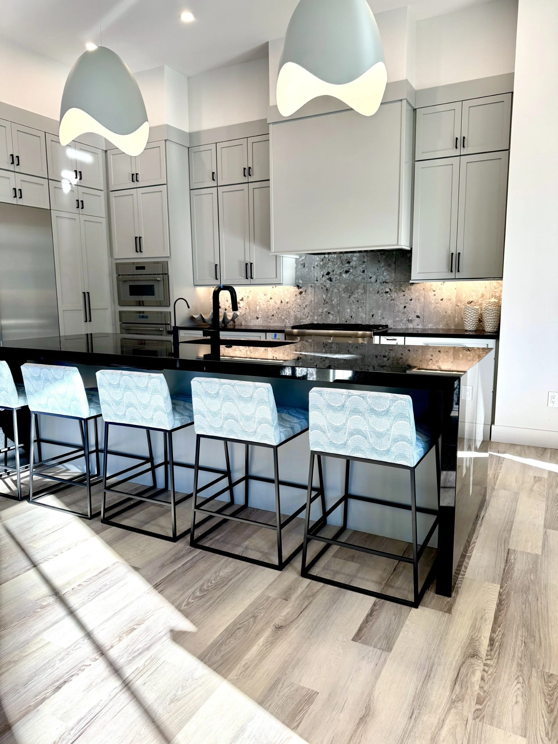 Kitchen barstools in blue wavy fabric at gray kitchen
