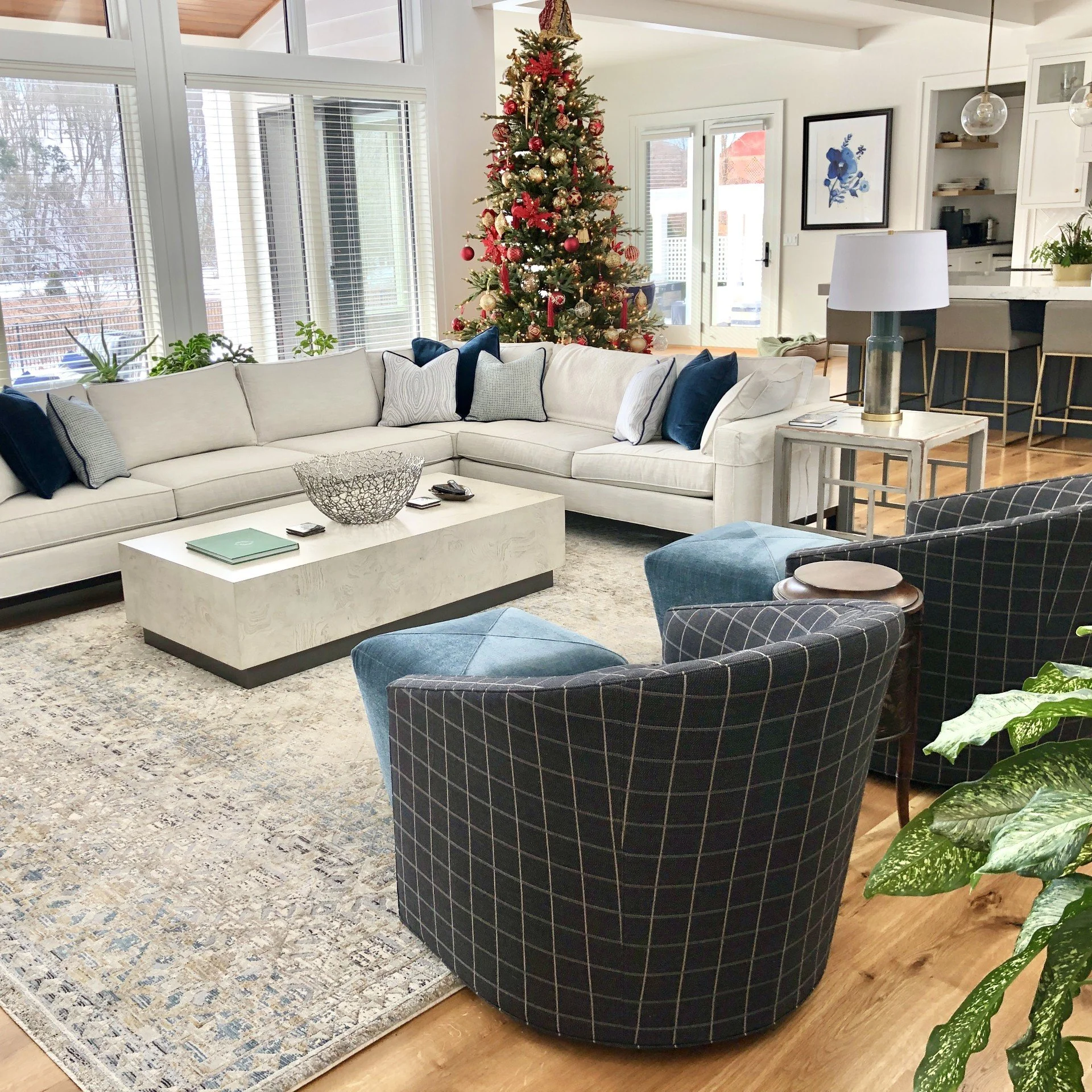 Christmas tree styled in a modern farmhouse great room with black windows and neutral decor interior design ethan allen