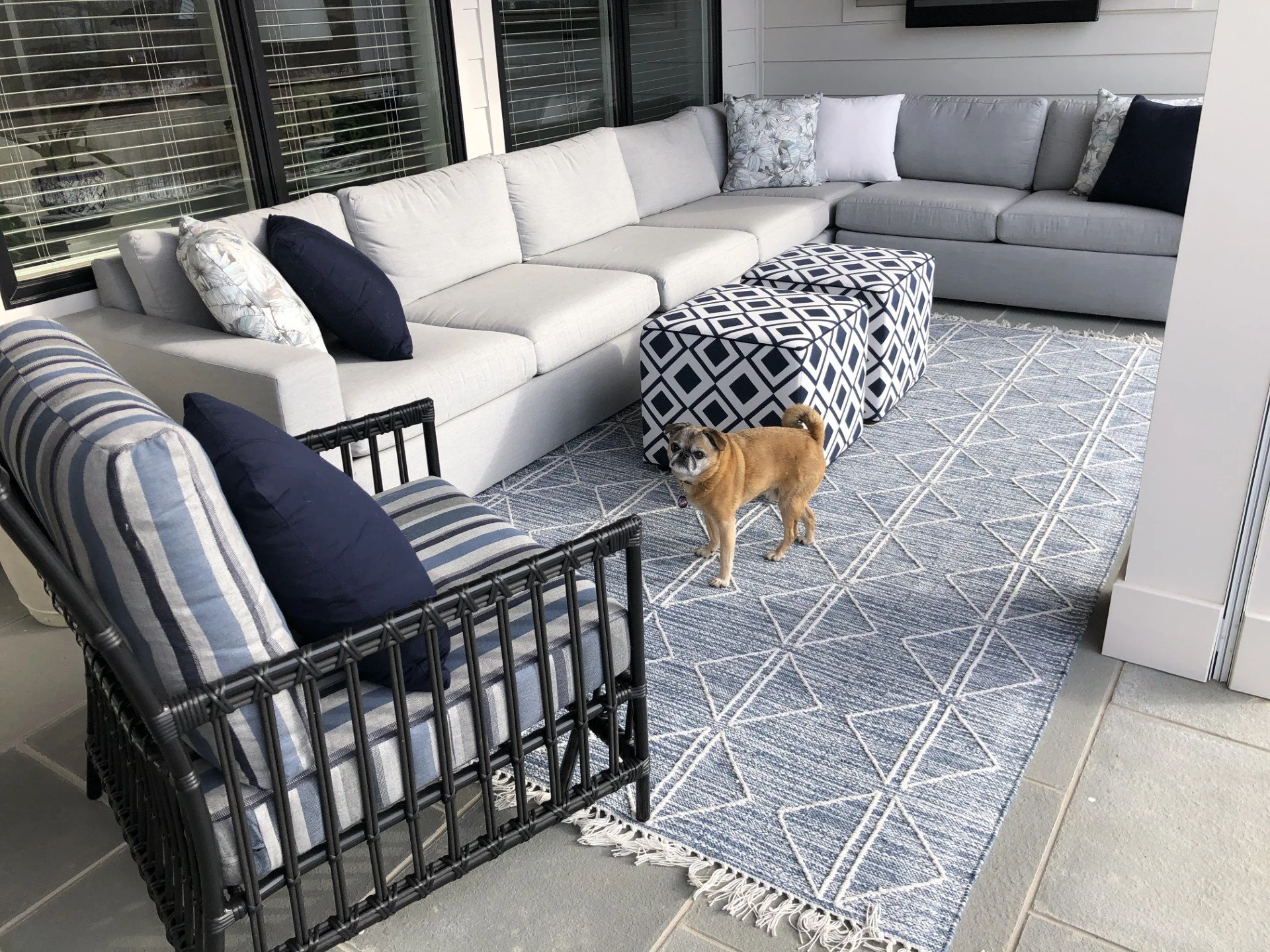 interior design ethan allen porch design patio furniture outdoor sectional with dog on rug in front of chair and patterned ottomans