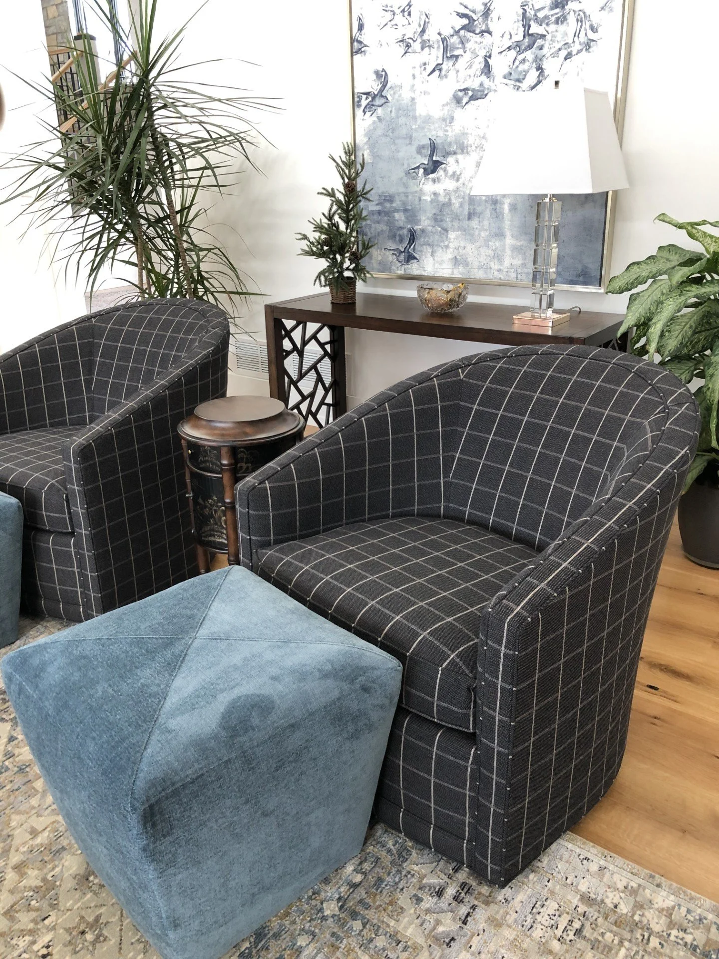 close up black plaid swivel chairs and teal velvet ottomans interior design ethan allen bird art and console table with crystal lamp and tree