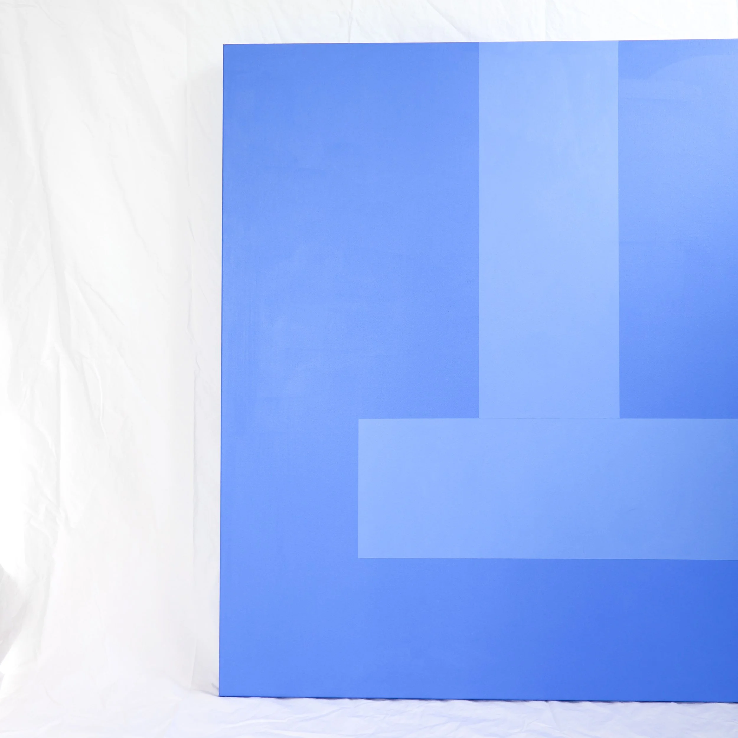 A blue square canvas painting, with pool line stripe in a slightly lighter blue, sitting on a white background.