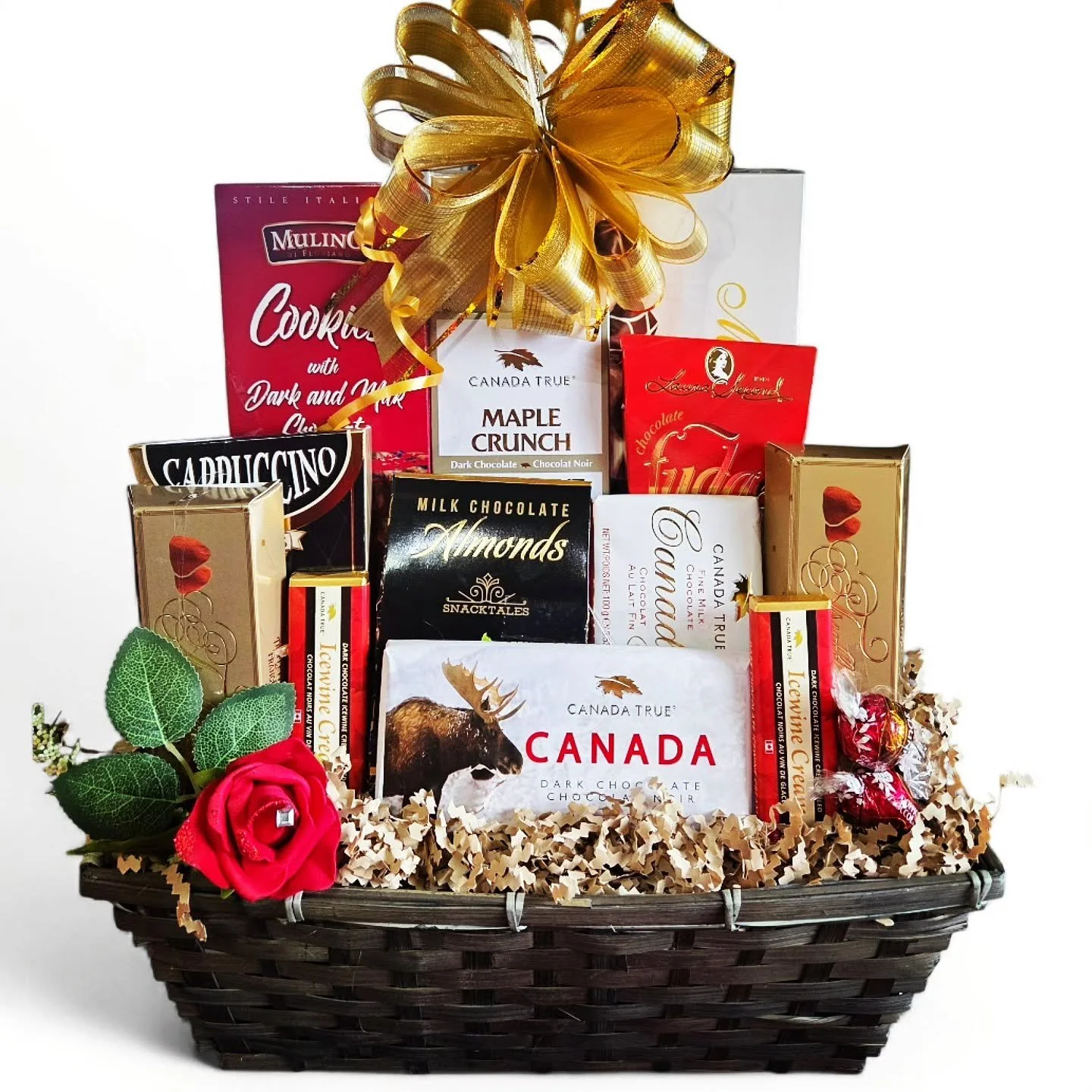 Gift basket filled with a variety of gourmet chocolates, chocolate bars, cookies, fudge, etc., adorned with a gold ribbon.