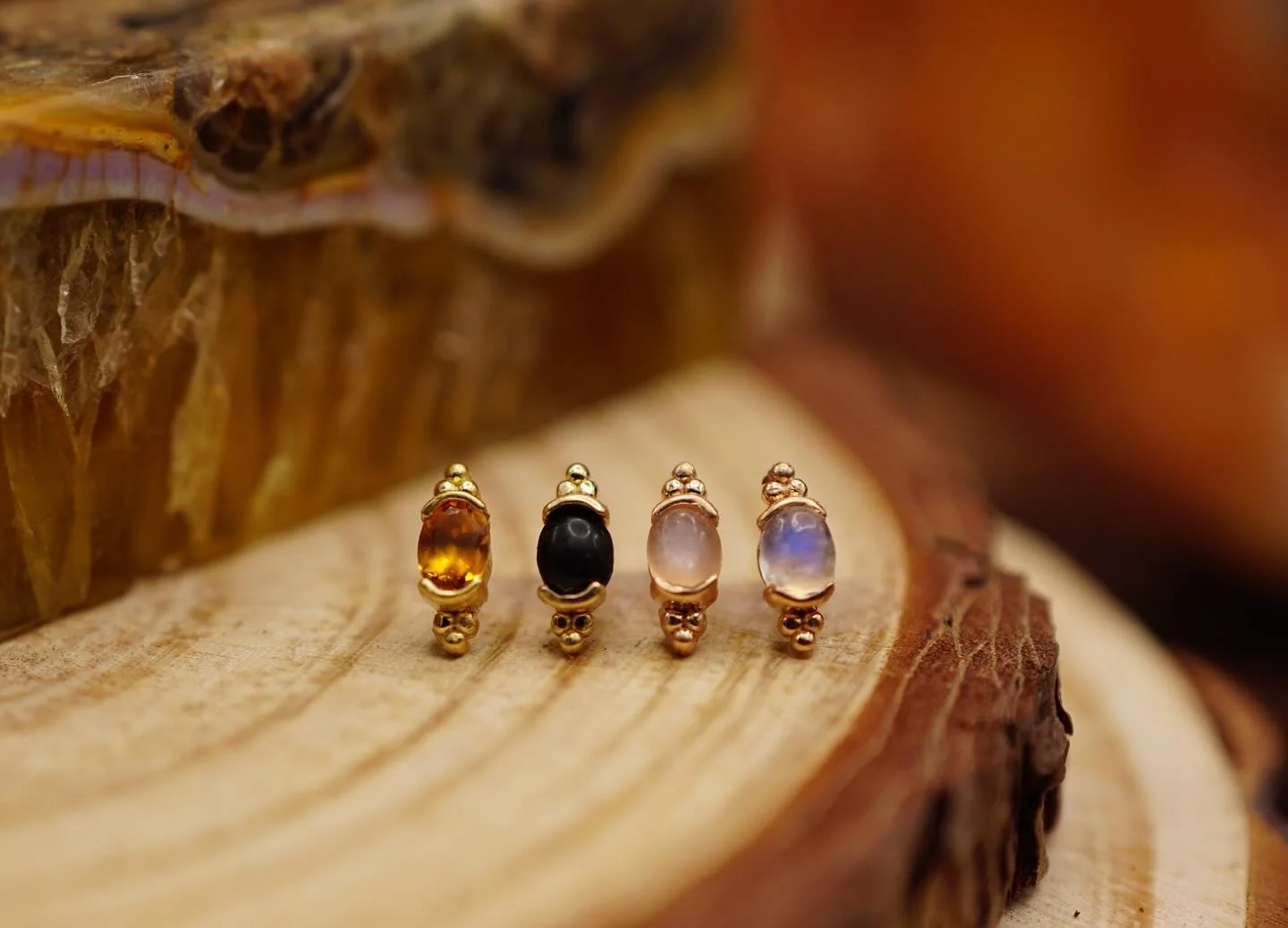 A few different stone variations of the &lsquo;Sonet&rsquo; end from our latest @quetzallijewelry drop. 

Pictured left to right is Citrine, Obsidian, Peach Moonstone and Rainbow Moonstone. ✨

#ceremonypiercing #safepiercing #workerowned #queerowned 
