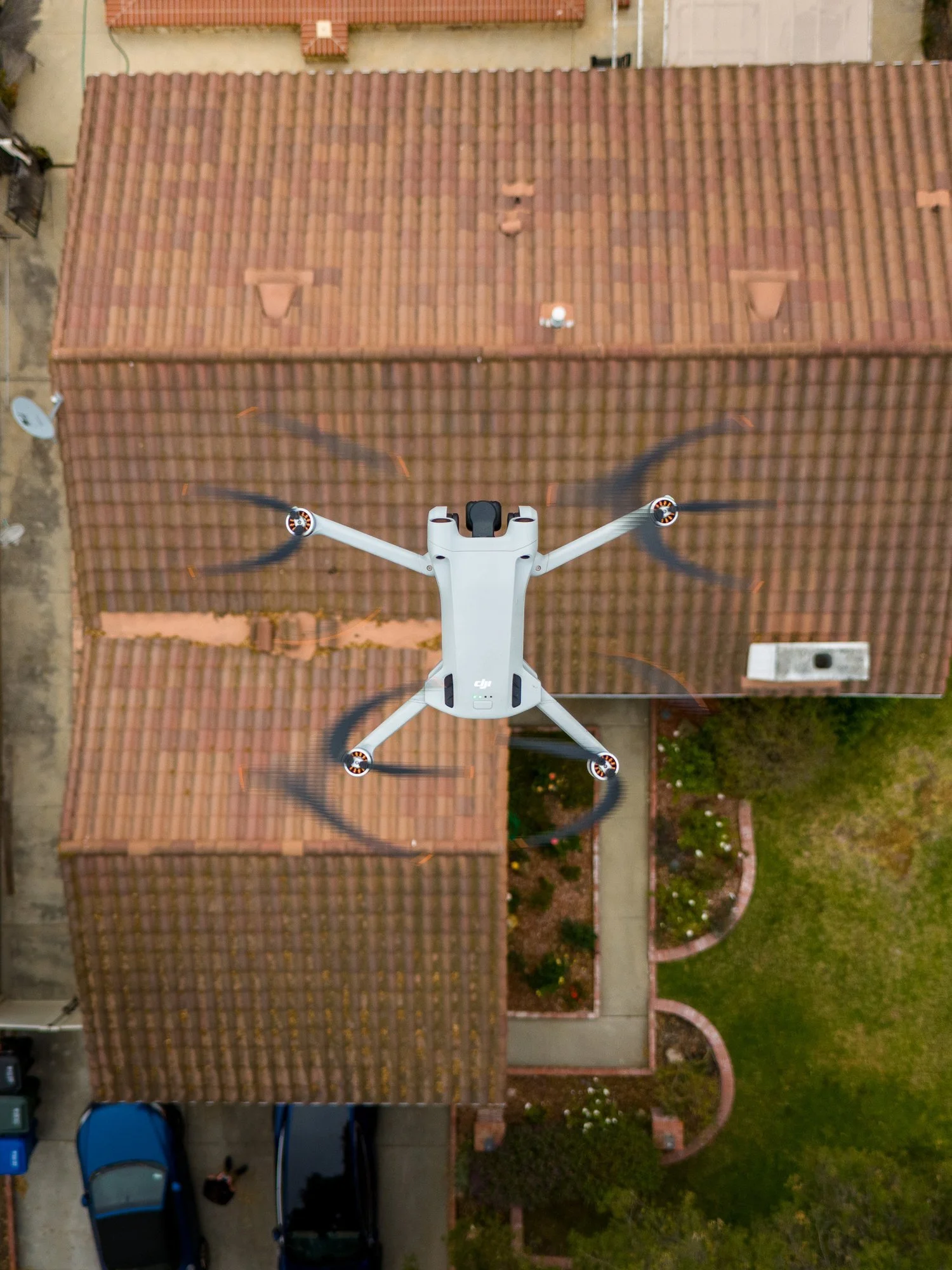 Drone hovering over a tile roof during a drone roof inspection in Ventura County