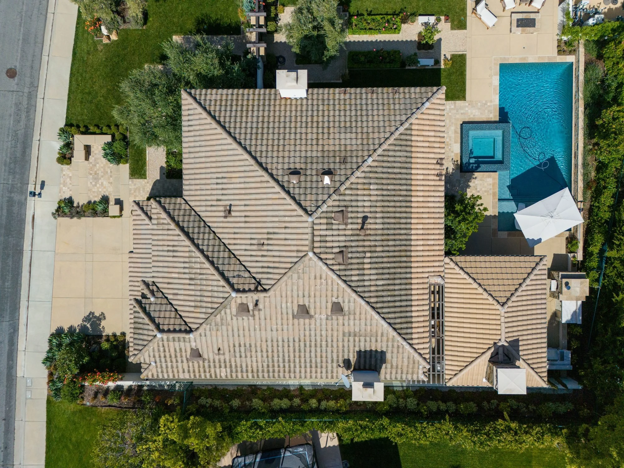 Overhead drone view of a Calabasas home's roof and backyard pool