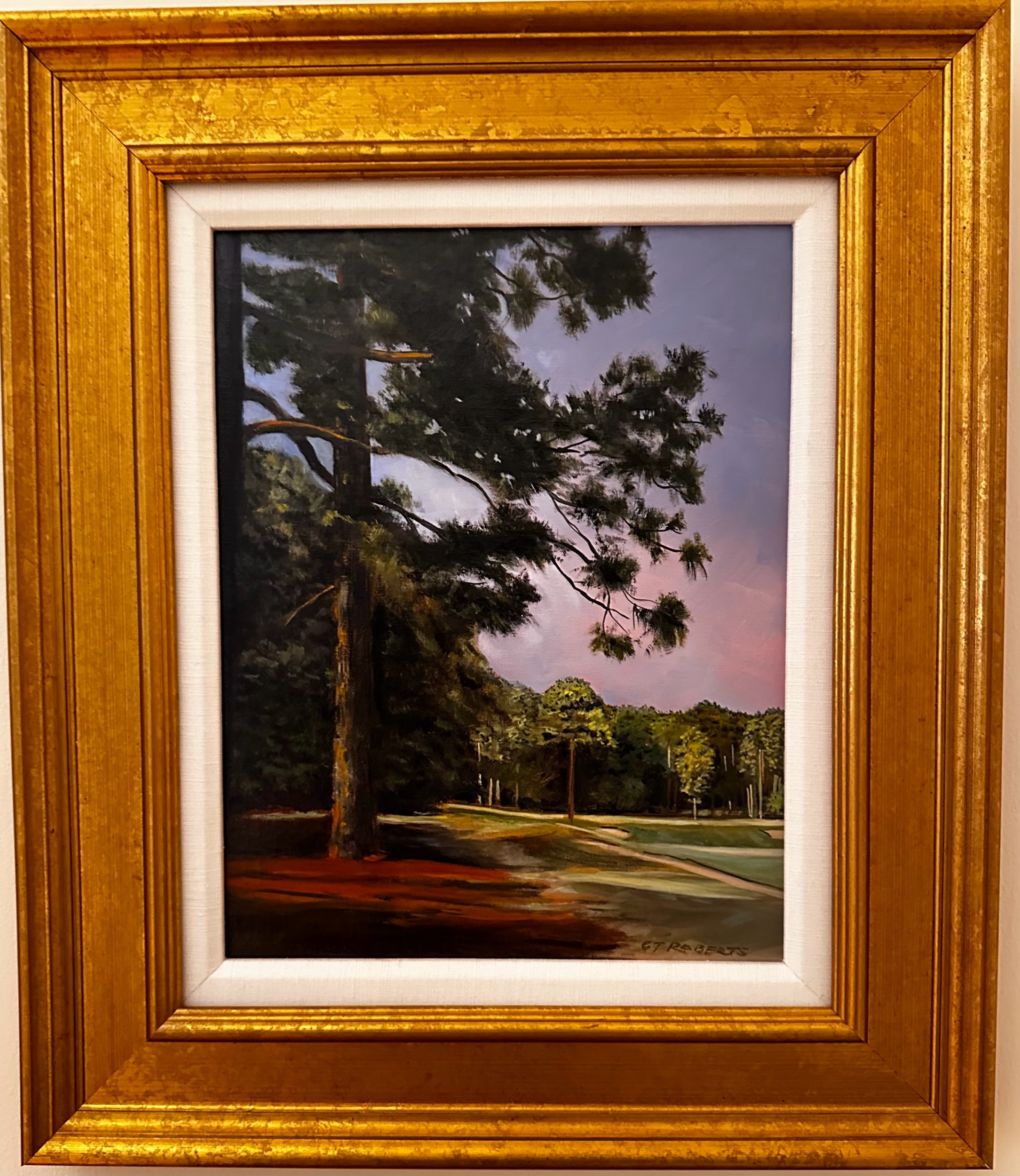 Painting of a challenging second shot to the green, showing a golfer's view from a rough surrounded by tall pine trees, with the green in the distance.
