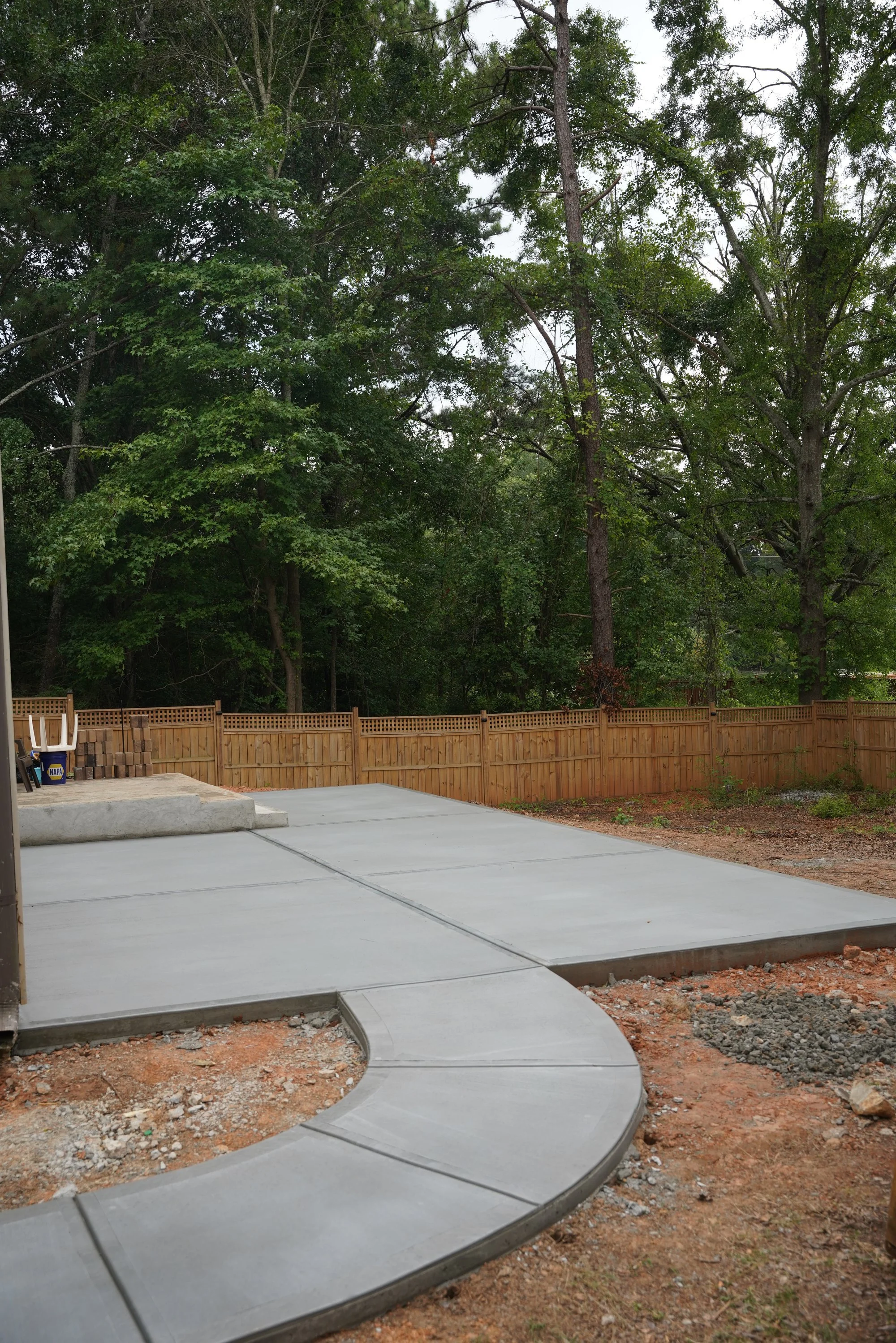 Concrete patio connected by a curved walkway in Atlanta