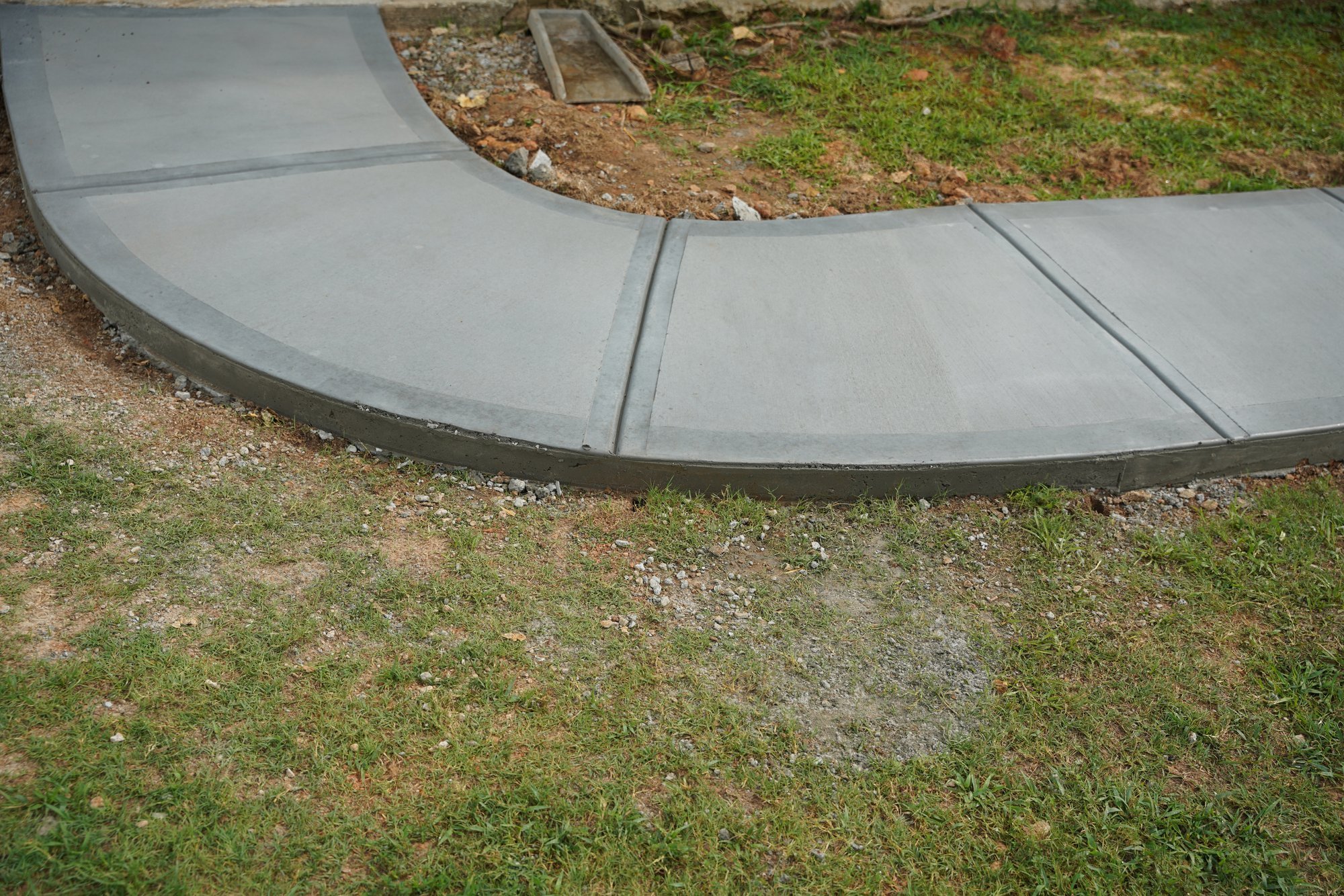 Curved concrete walkway and patio by Quality Concrete Solutions in Atlanta
