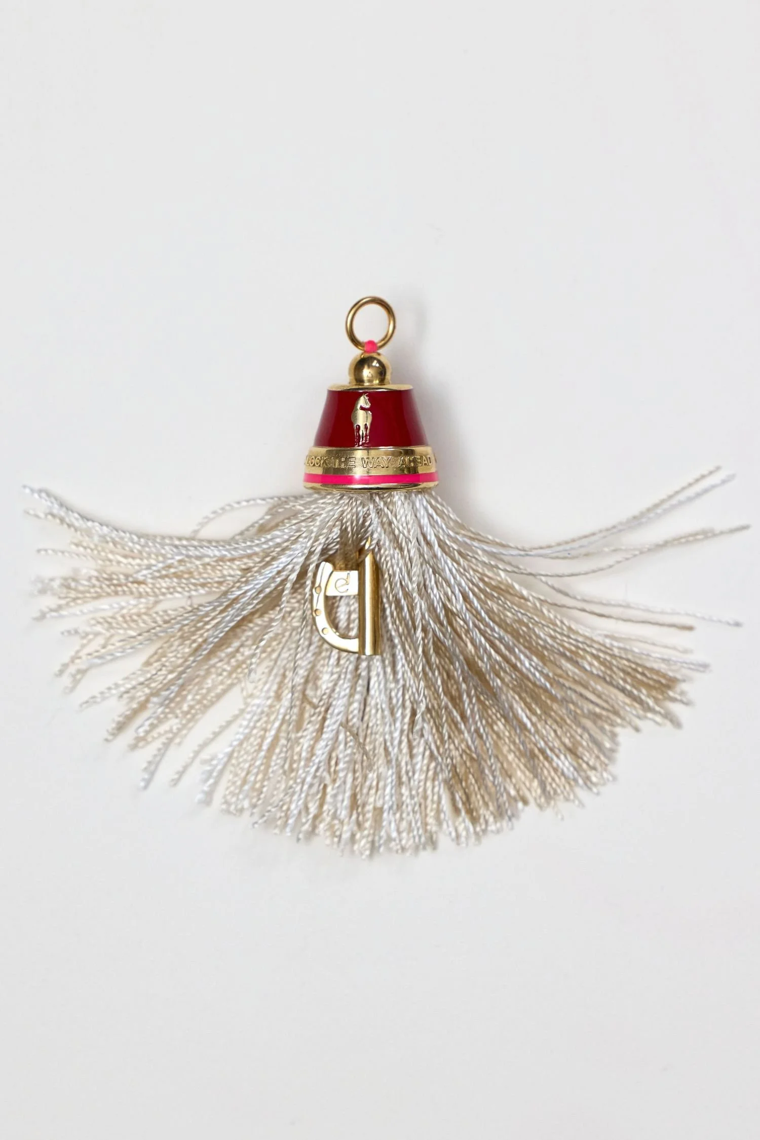 key detail of 14K gold horse tassel pendant with enamel