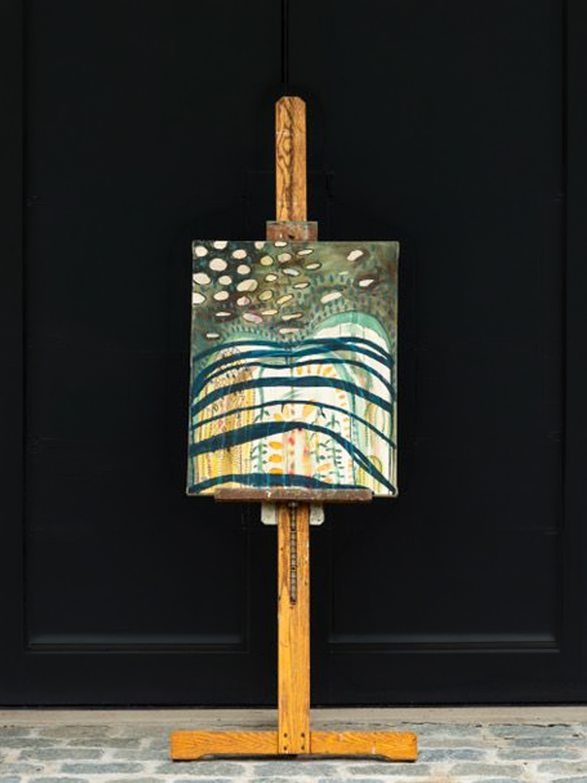 Secret Island, 2024, Acrylic & oil on raw canvas, by Elaine Chong on easel in front of black wall