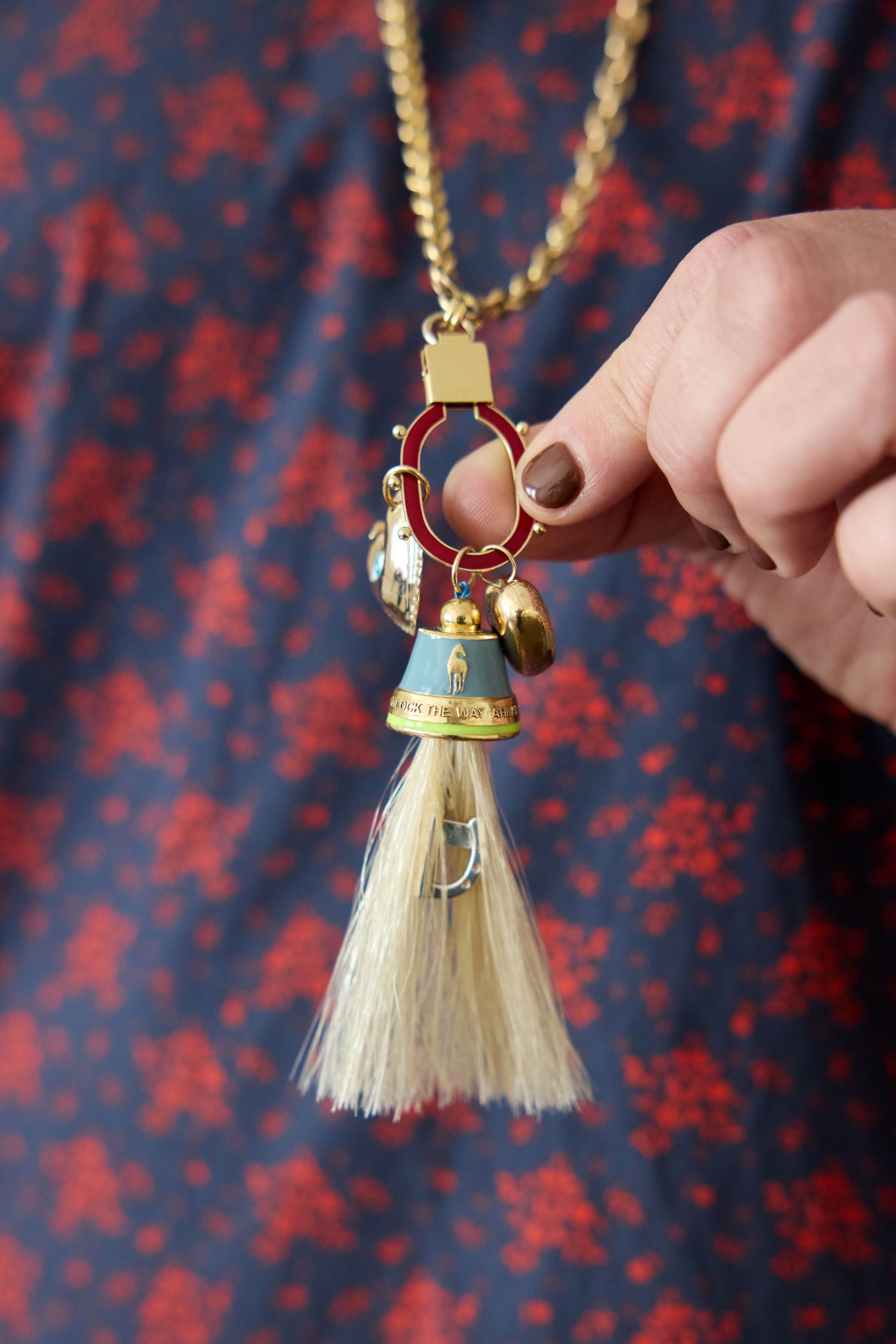 14K Gold Horse Tassel Pendant with Blue Enamel on model, by Elaine Chong Designs
