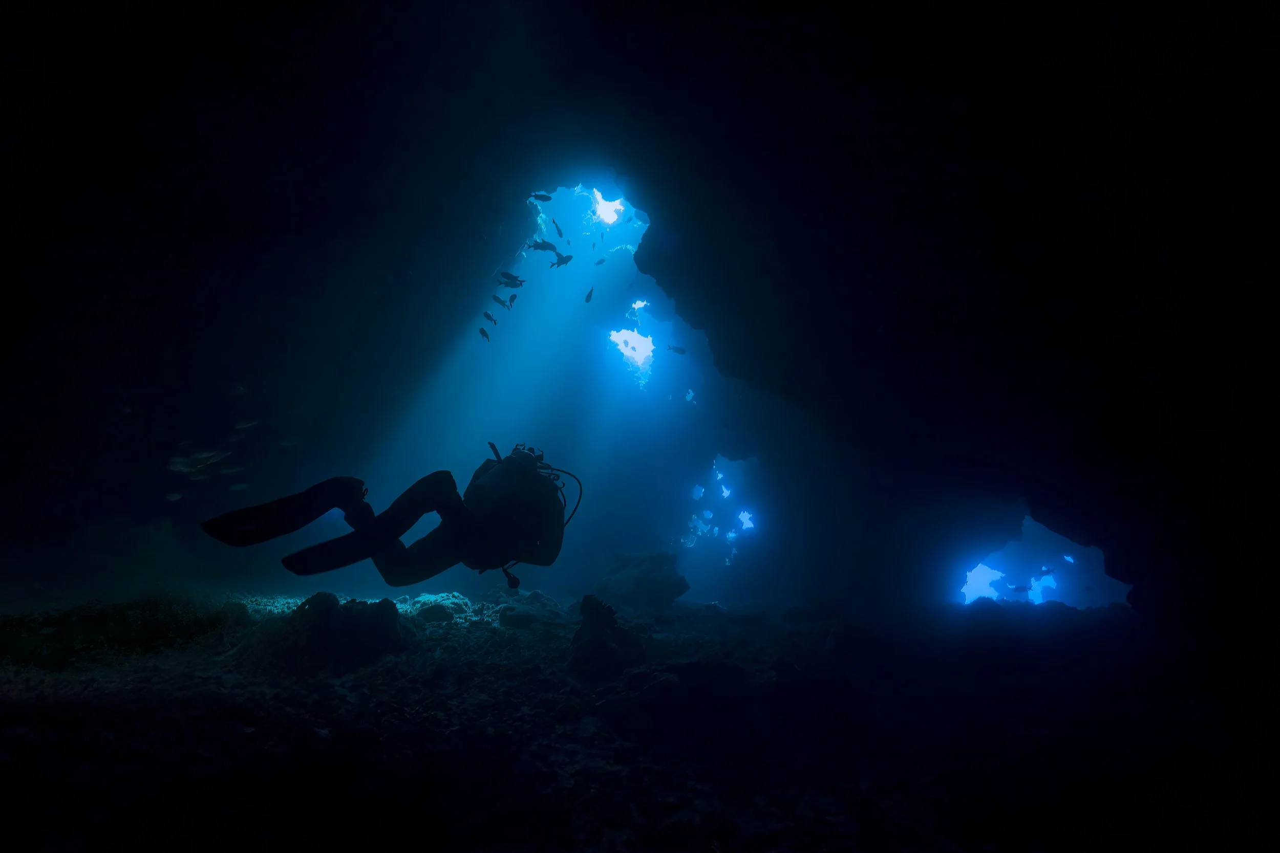 Silhouette of Diver in a Cave