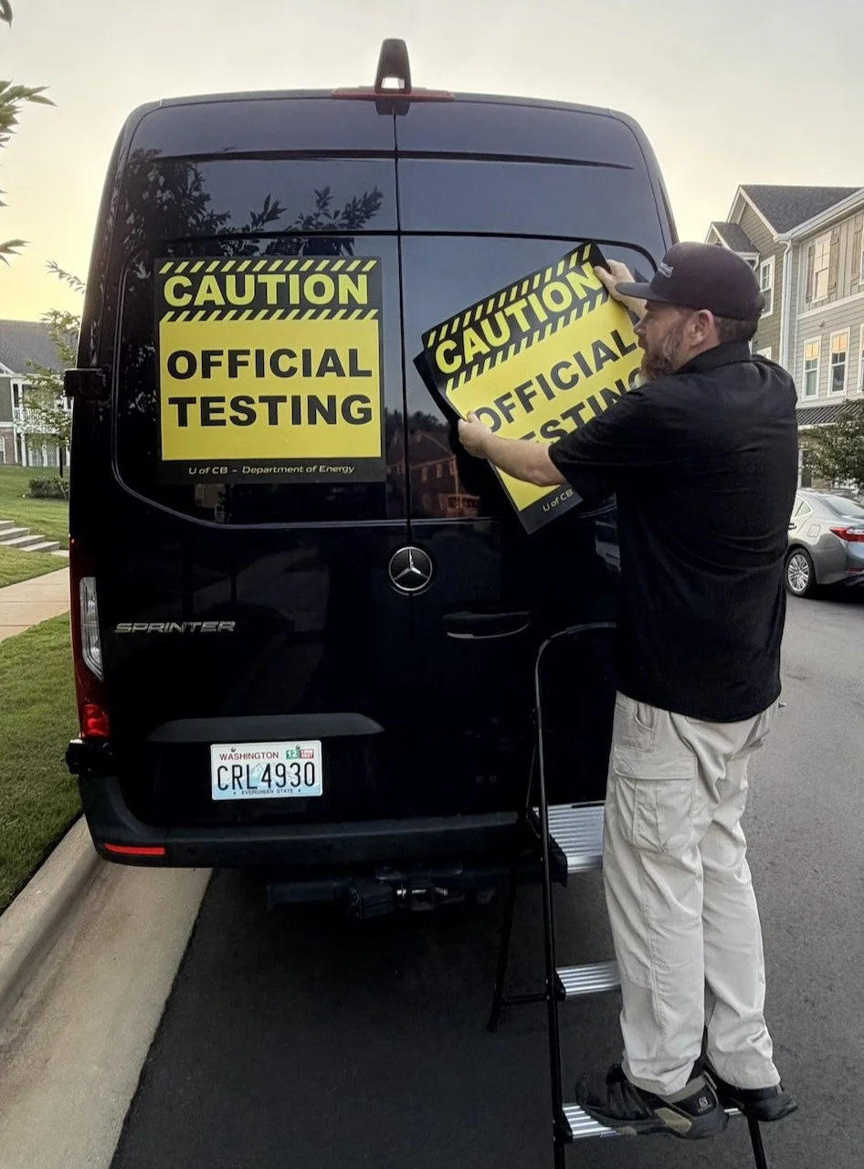 The University of C.B., Department of Energy magnetic signs fitted to the back of the Sprinter support van.