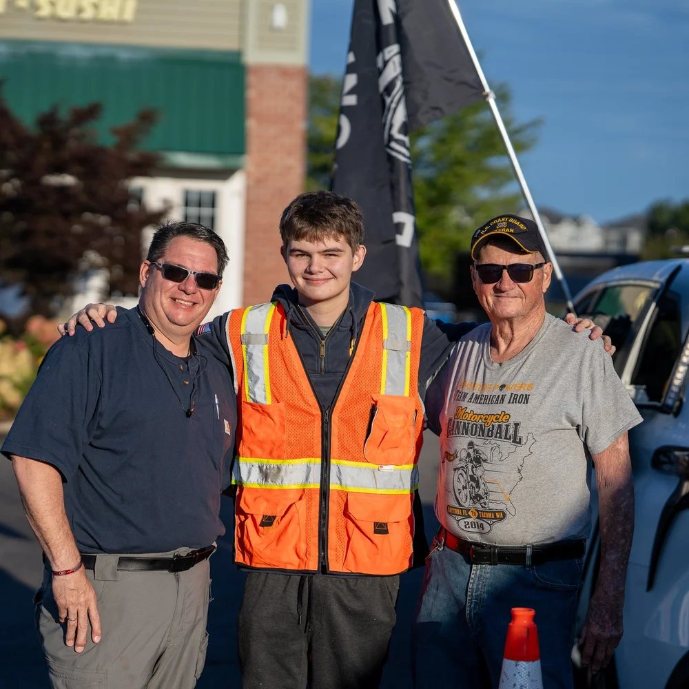Three generations of the Coffin family standing together at the start