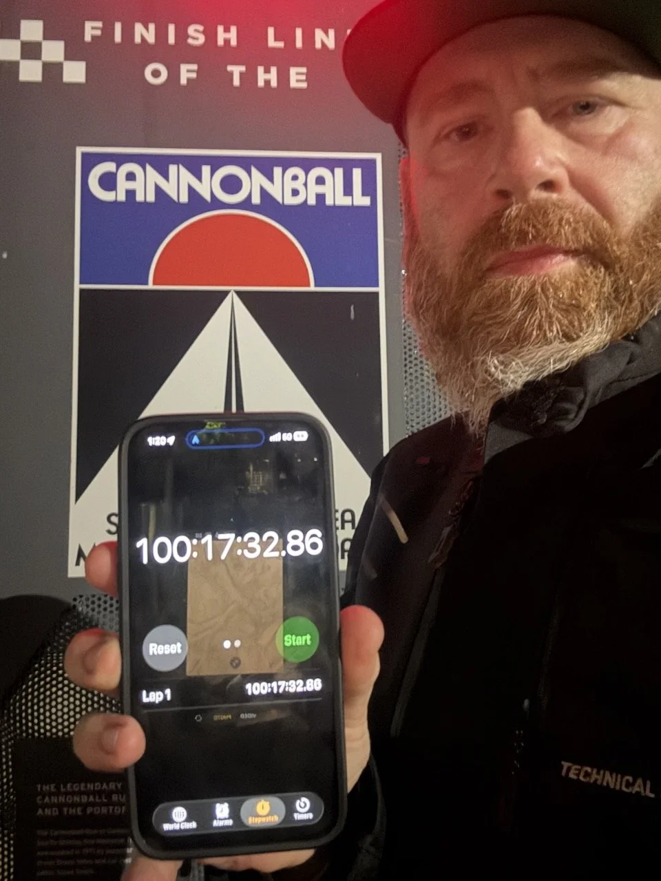 Aaron Pufal at the finish line monument at the Portofino Hotel, timer stopped at 100 hours 17 minutes.