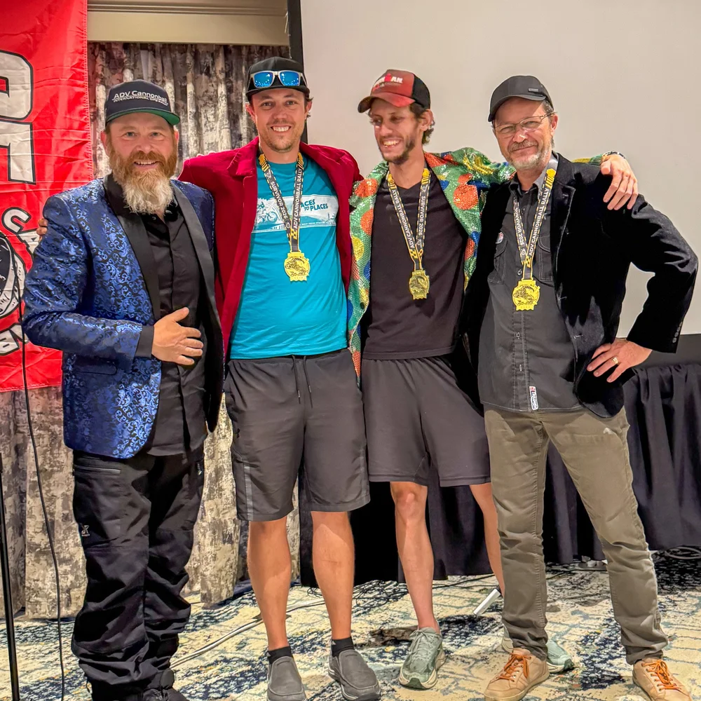 Three members of Team Pyro FX wearing finisher's medals at the awards banquet