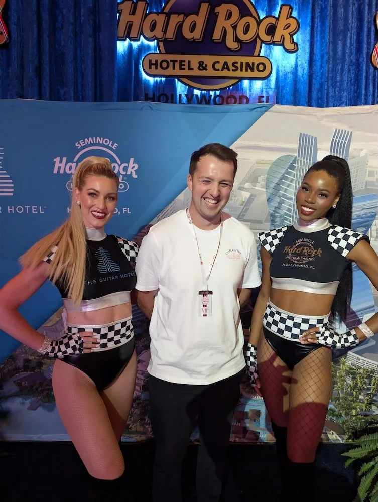 A bashful Tommy Davies poses with two start line girls at the Hard Rock Hotel in Miami