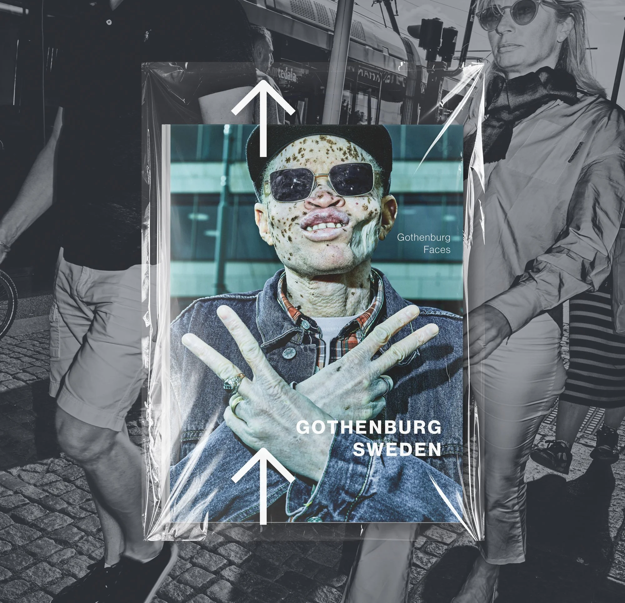 People walking on a cobblestone street with a city bus in the background. The photo features a large poster of a person wearing sunglasses, with the text "Gothenburg Faces" and "Sweden" on it, overlaid with arrows and a semi-transparent cover.