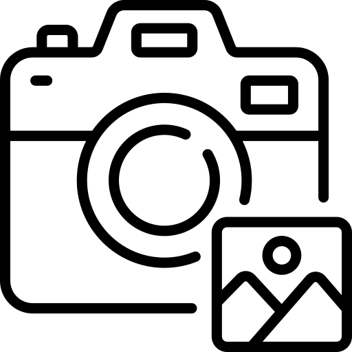 Black silhouette of a bear standing upright with trees in the background.