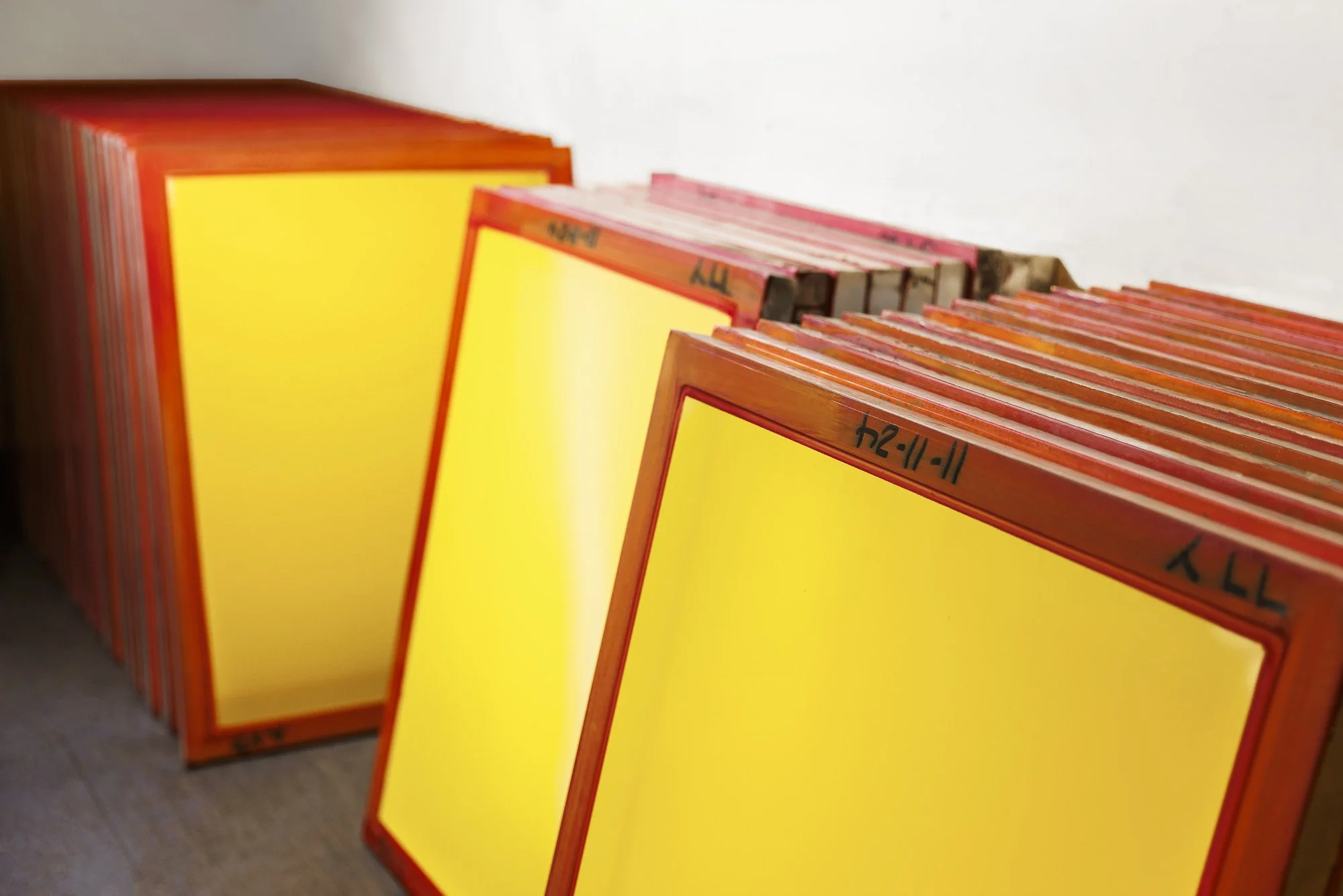 screen printing screens prepared and aligned for consistent production and stencil setup process