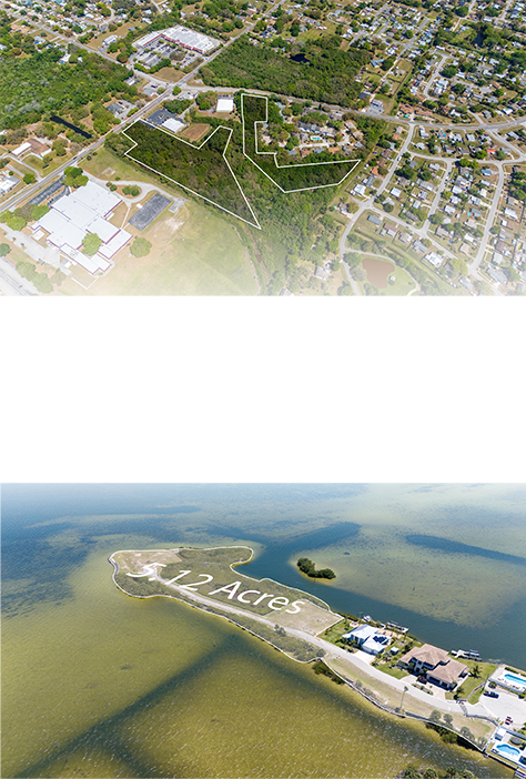 Aerial view of a 2.12-acre property with outlined boundaries in a waterfront setting, including nearby residential area and water.
