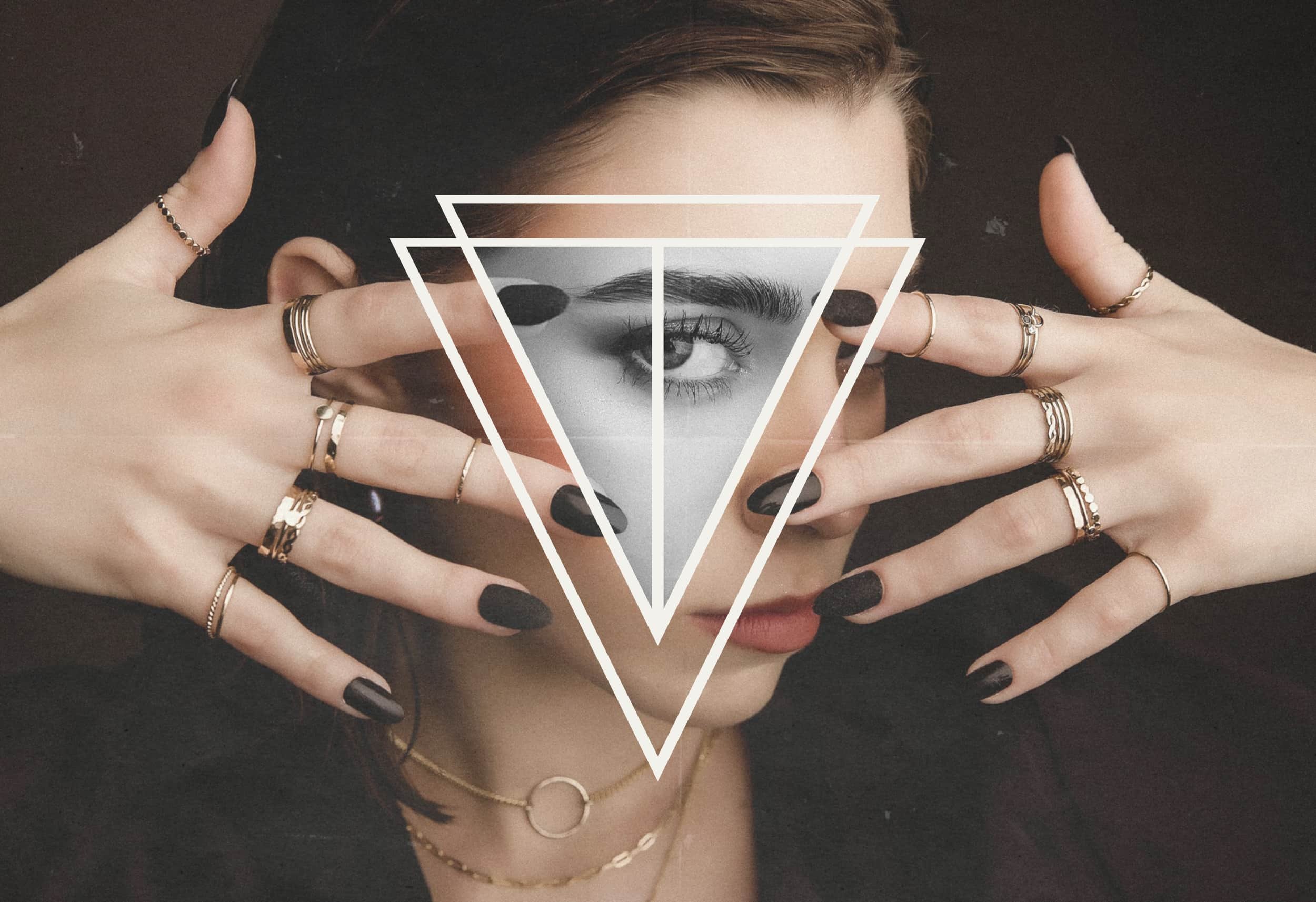 a close-up of a woman with longs nails and lots of rings