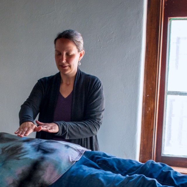 Reiki practitioner working on a client