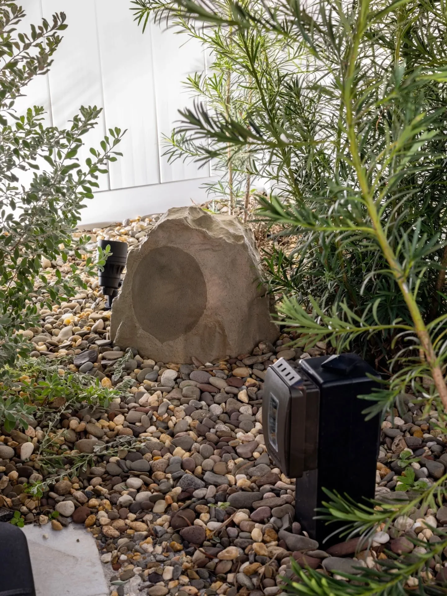 [INTEGRATED BY DESIGN] 

One of the most intentional details in this yard isn&rsquo;t the putting green.

It&rsquo;s the integrated power and audio system.

From the beginning, the receptacle and rock speaker were part of the design &mdash; thoughtfu