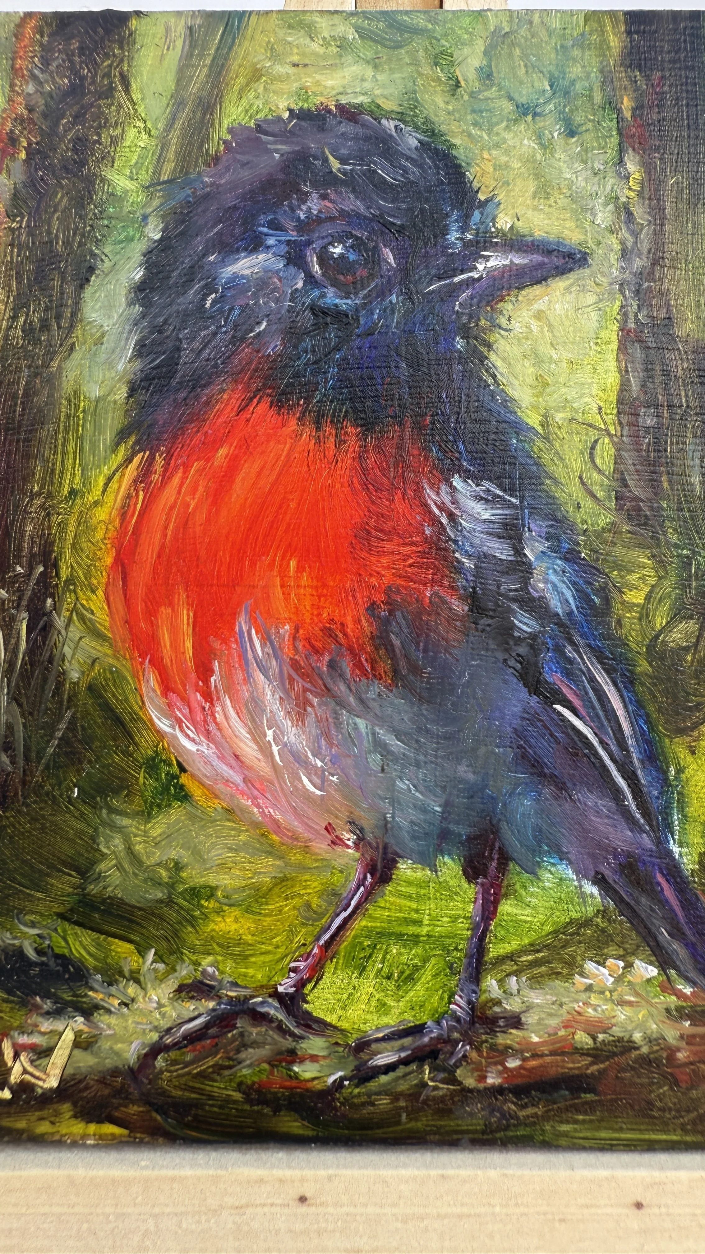 Mini oil painting of a red-chested robin standing on a branch, close up