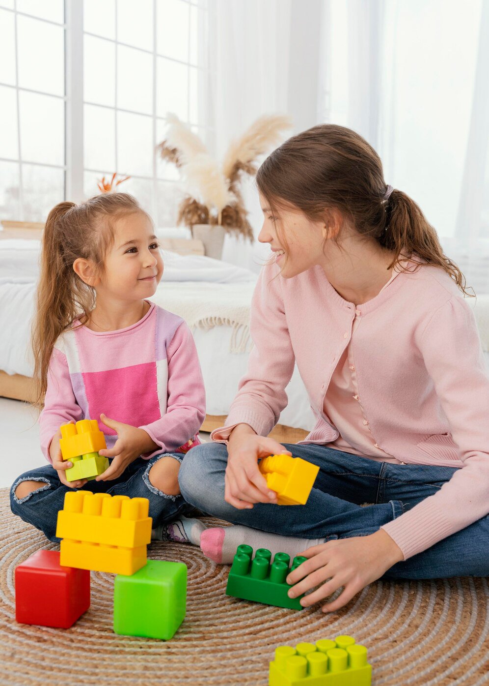 front-view-two-sisters-playing-with-toys_23-2148890916.jpg